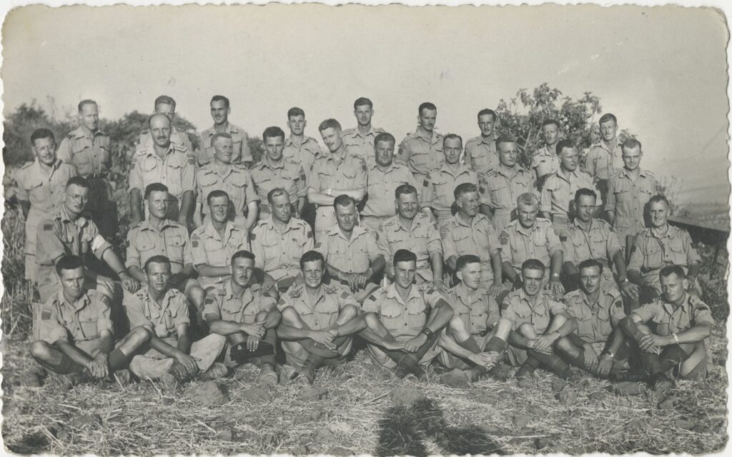 A photo of the Loyal Edmonton Regiment from 1943 that shows a group of 35 young men dressed in a short-sleeved uniform.
