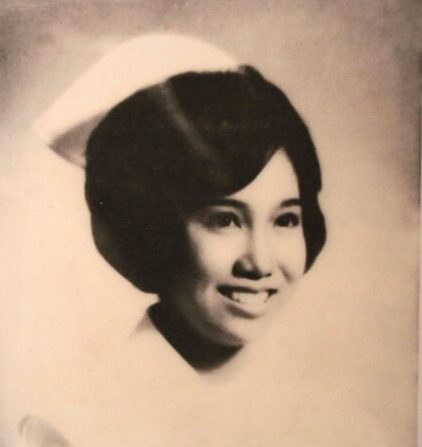 Tessie Oliva, a young Filipina woman, pictured in a nursing school graduation photo wearing a 1960s white nursing uniform.