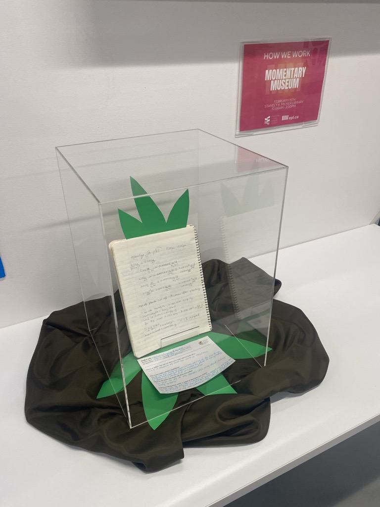 A photo of a spiral notebook in a display case