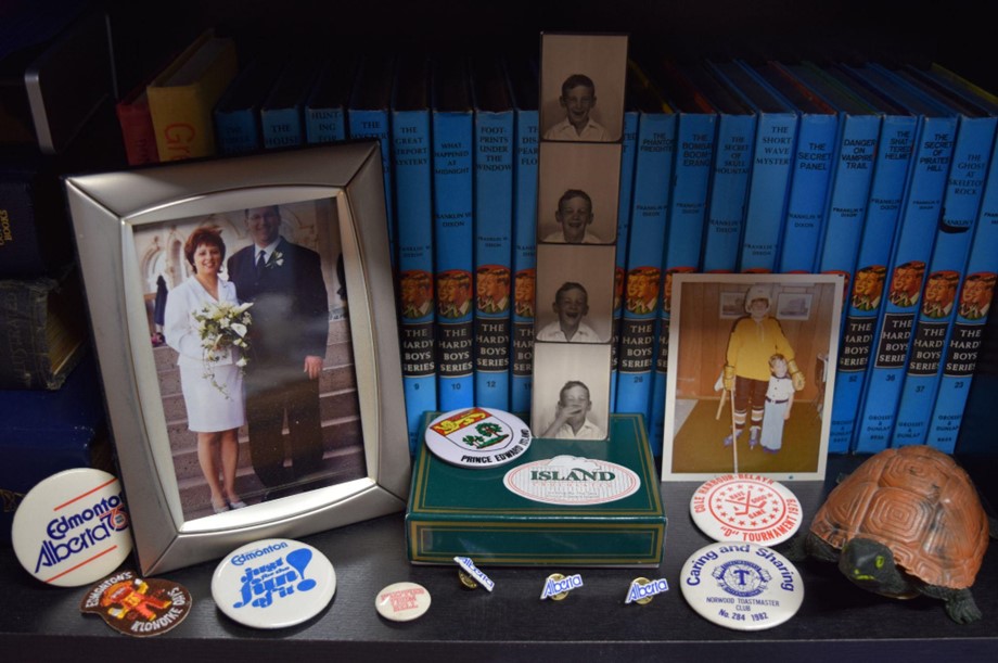 A photograph of items from Larry Svenson's life, including photographs and pins.