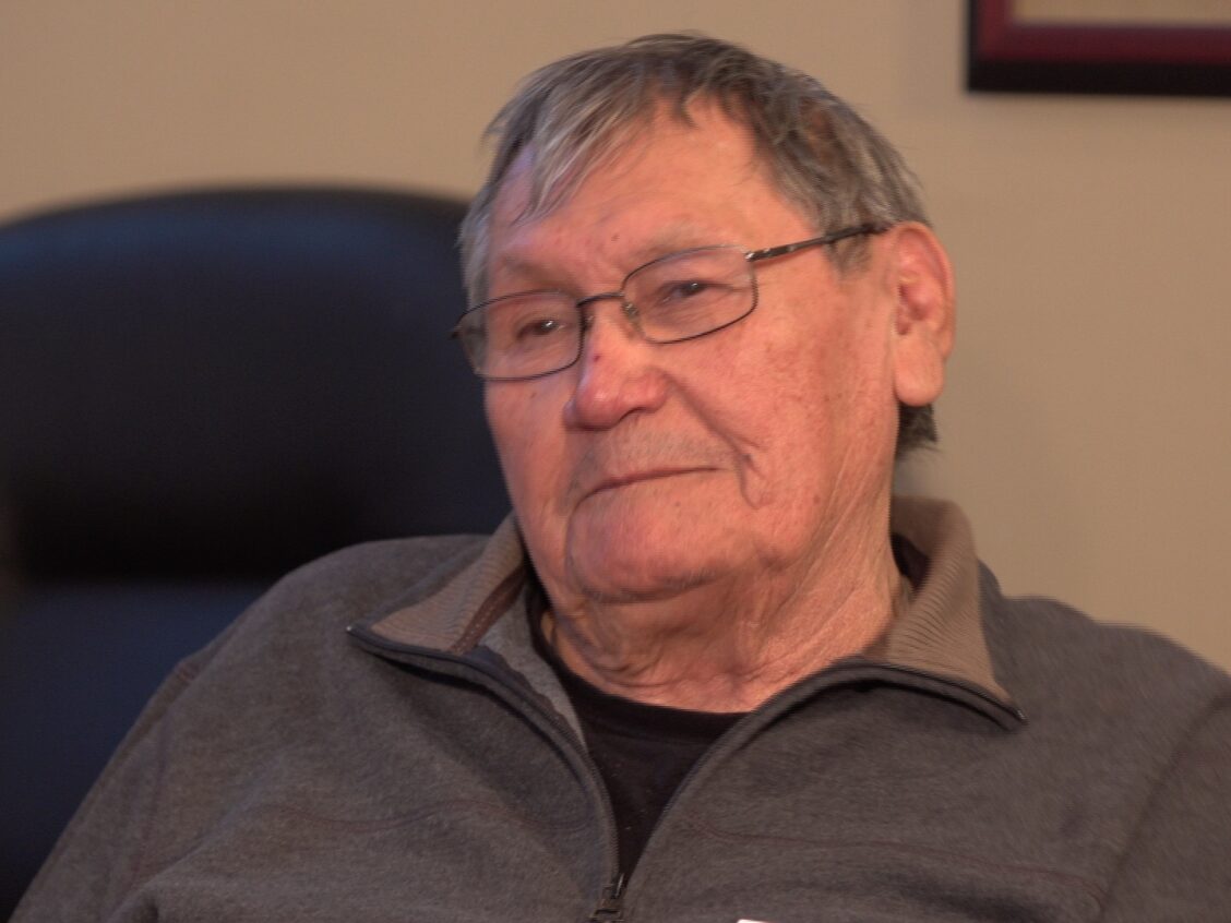 A photo of an Tom Daniels, one of the ironworkers featured in Alvin Finkel's story Waltzing with the Angels. Here he is an older man with glasses, sitting in an office.