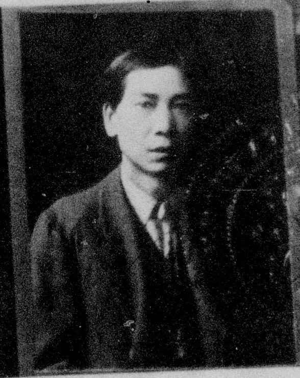 A black and white formal photograph of a Chinese man, Sam Sing Mah, looking somberly at the camera. He is clean-shaven.